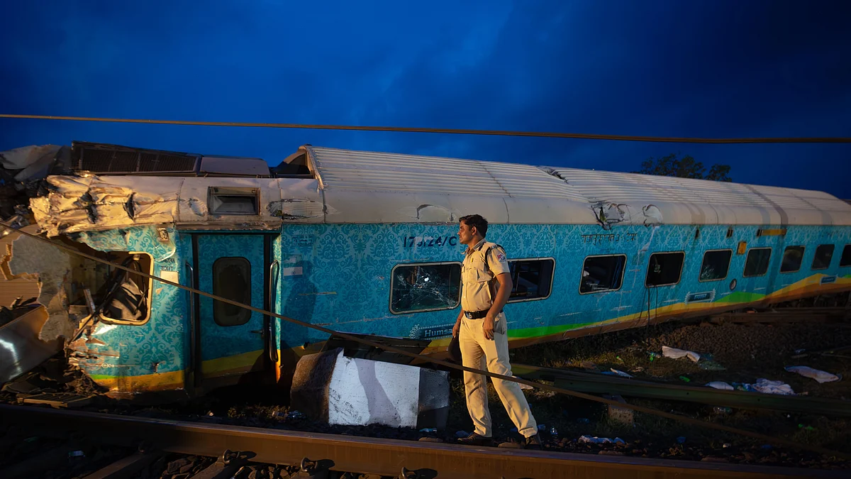 A police officer maintains vigil near the wreckage of the three trains in the accident on 3 June 2023 in Odisha's Balasore district (photo: Abhishek Chinnappa/Getty Images)