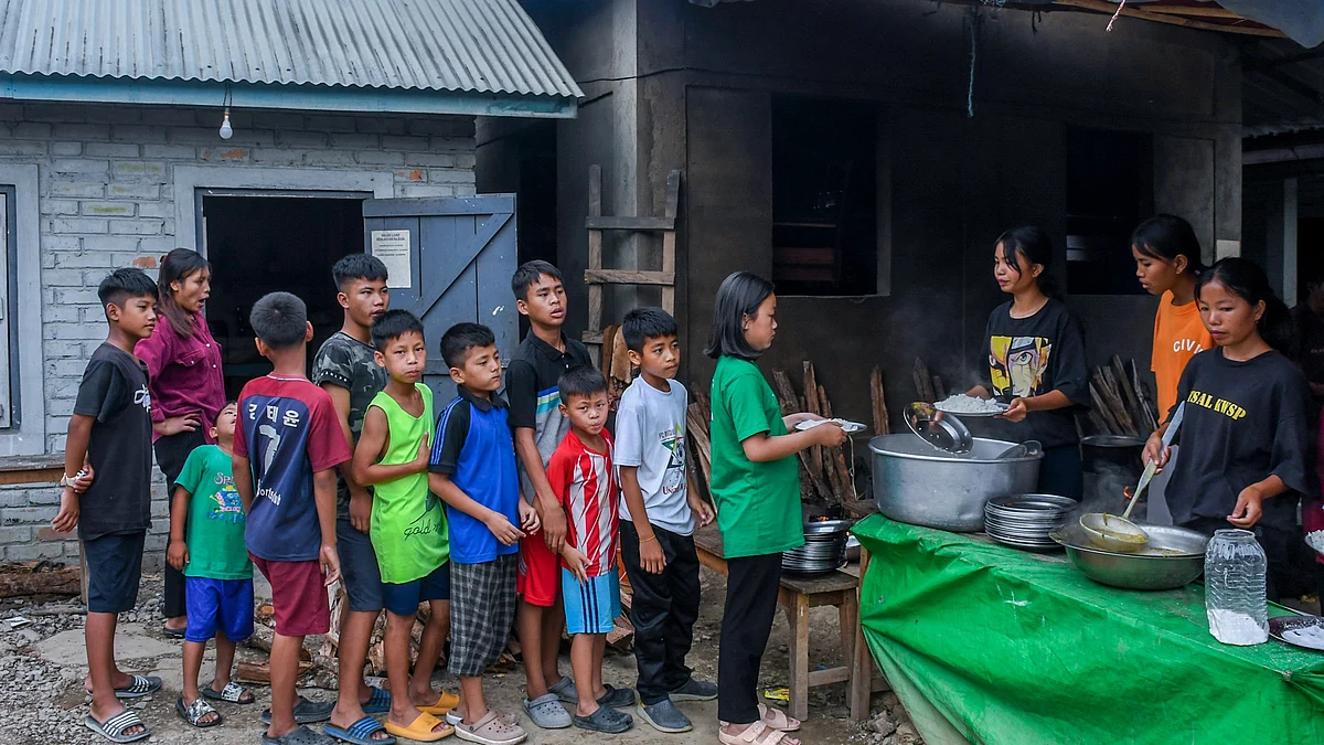 Churachandpur, Manipur: Children wait in a queue to receive food at a relief camp in Rengkia village (photo: Getty Images)