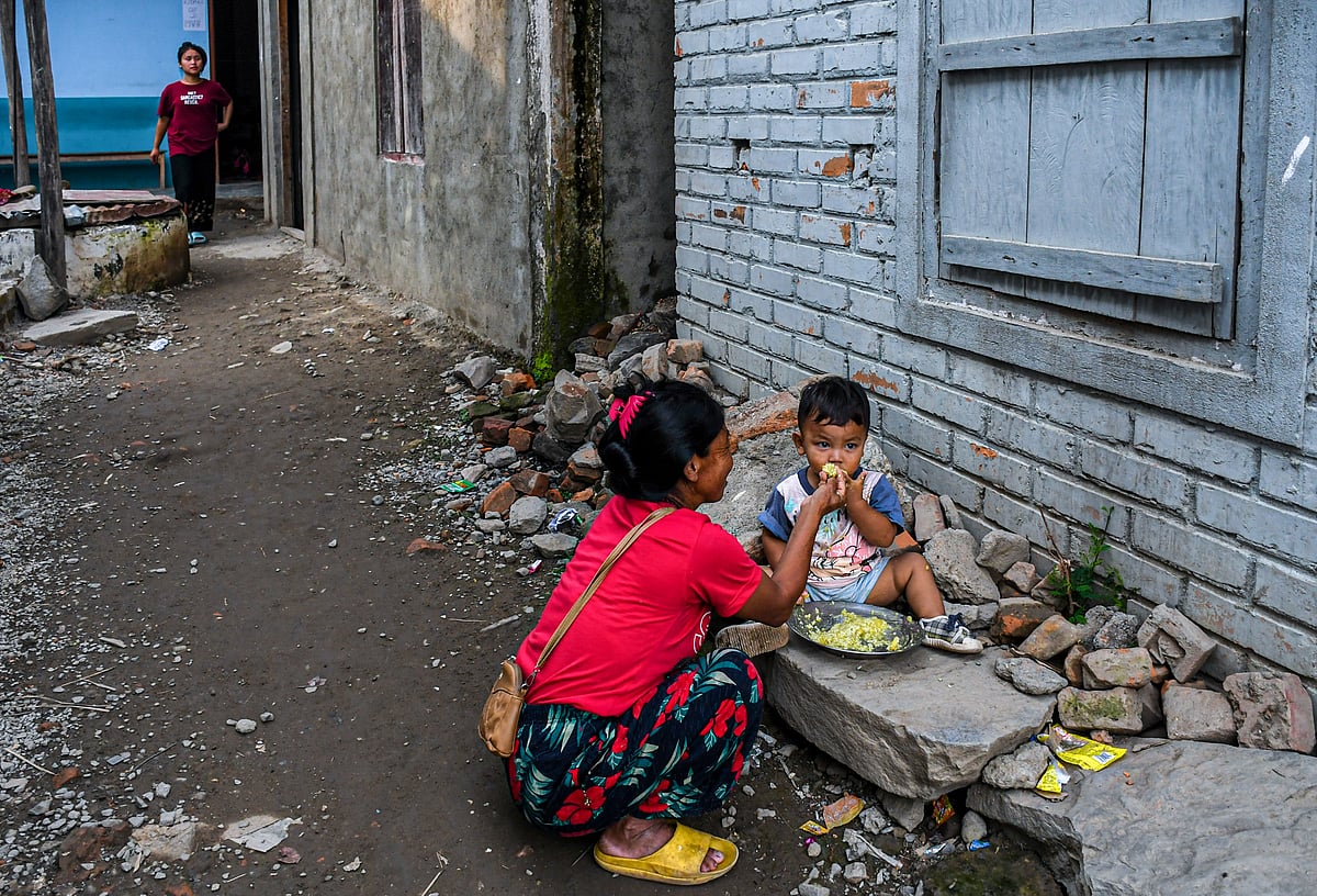 Churachandpur, Manipur: A mother feeds her son at a relief camp in Rengkia village (photo: Getty Images)