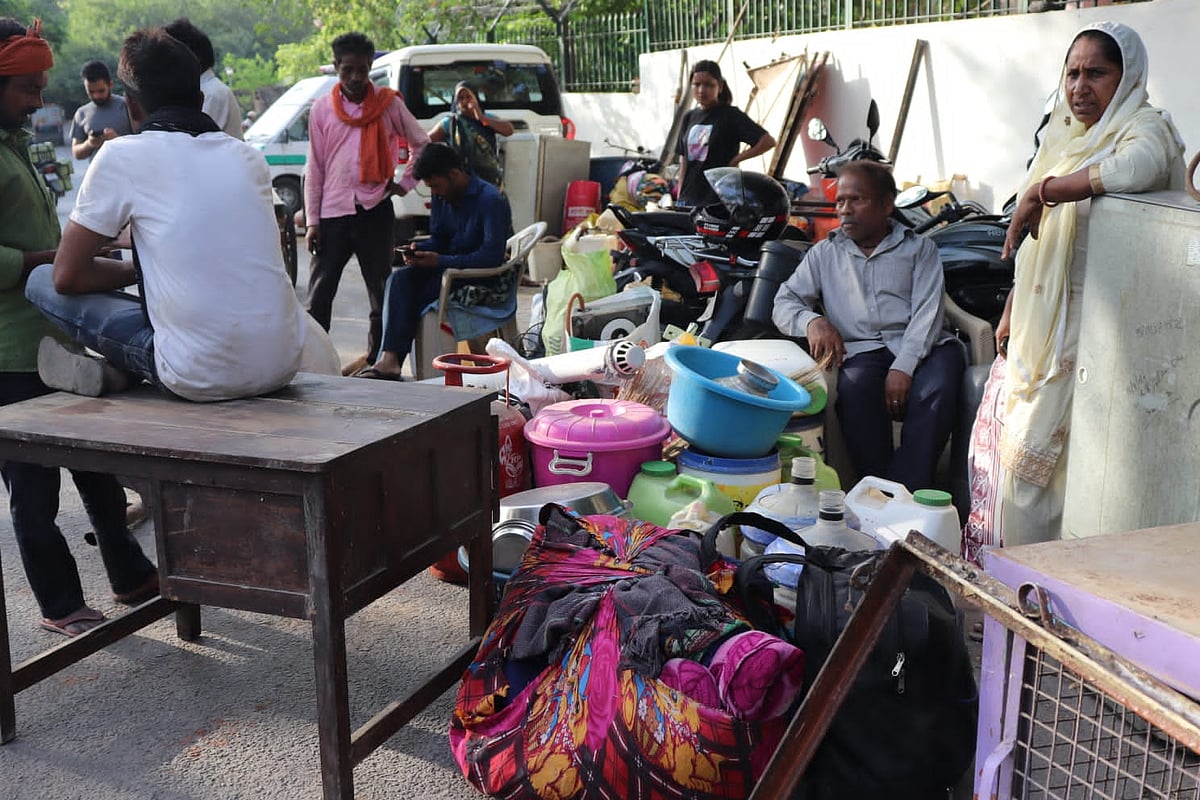 Residents waiting outside the gates with their belongings (Photo courtesy: AICCTU)