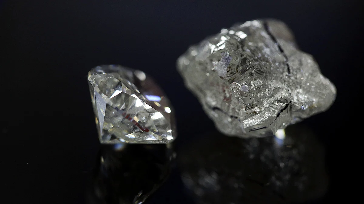 A finished round-shaped diamond and an uncut diamond with cutting marks are displayed in this arranged photograph (photo: Getty Images)