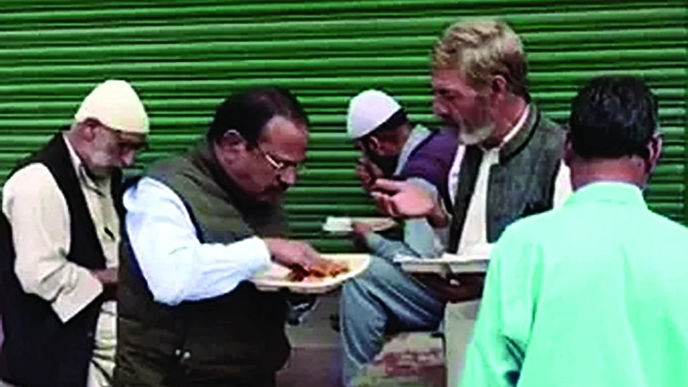 National security advisor Ajit Doval shares food with some locals in Srinagar in 2019