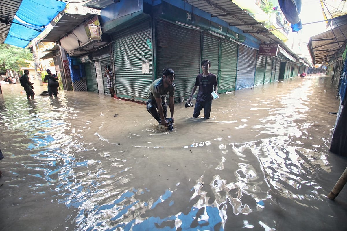The hassle of clearing rainwater at Tibetan Monastery (Photo: Vipin/National Herald)