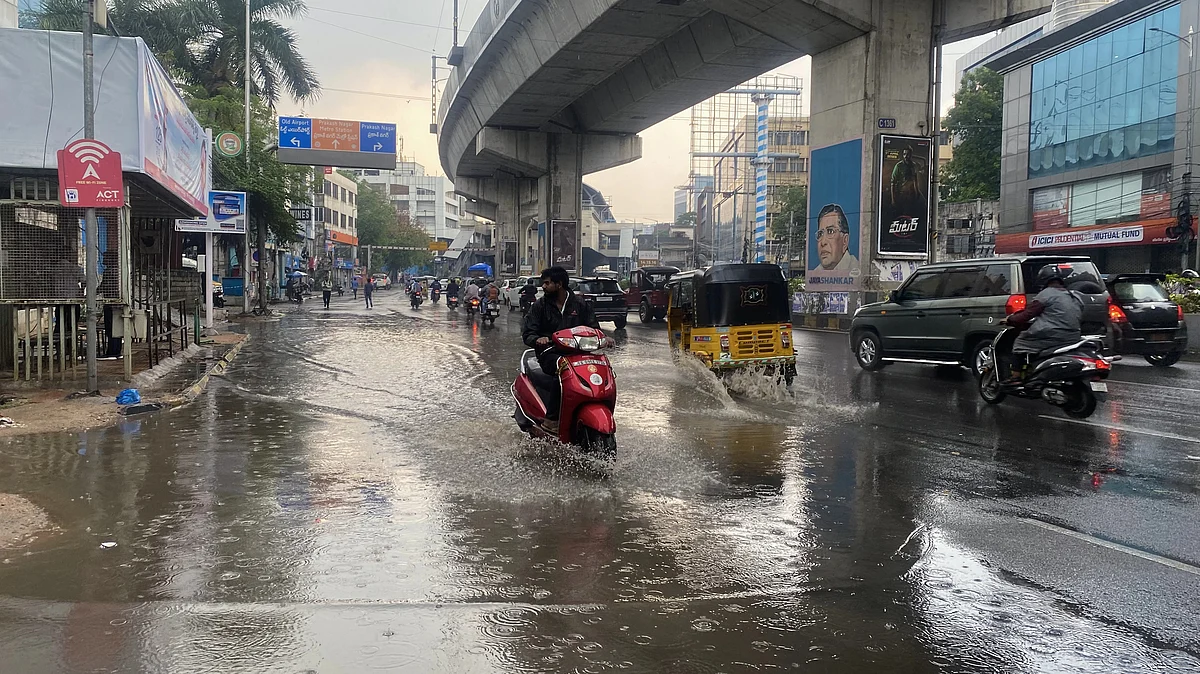 Residents wade through a water-logged street at Prakash Nagar in Begumpet, Telangana (Photo: Getty Images)