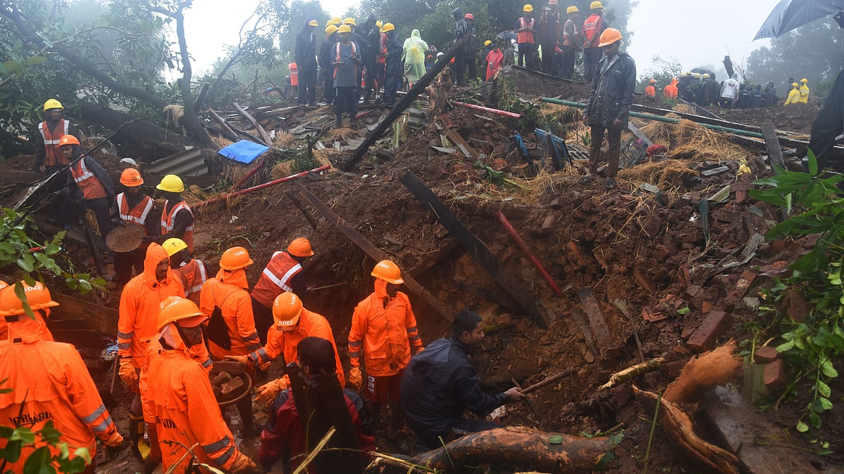 Rescuers work at a site of a landslide triggered by torrential rains in Raigad district, western Maharashtra (Photo: Getty Images)