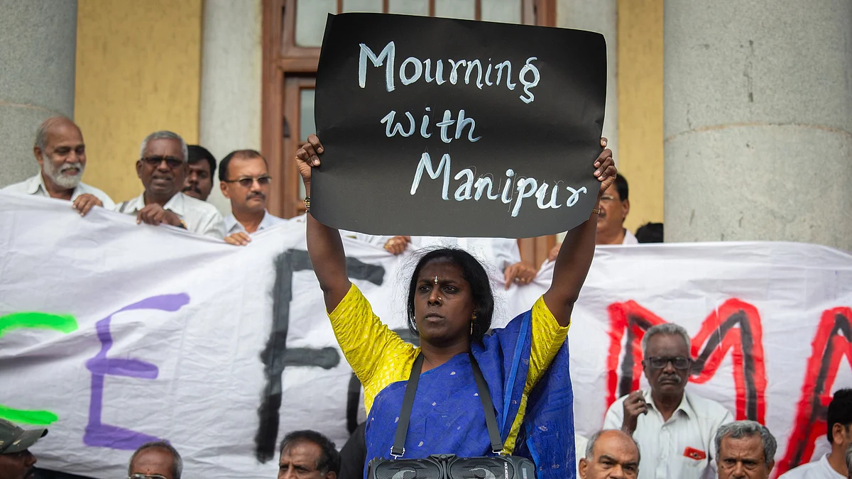 Black poster saying 'Mourning with Manipur' held up by Akkai Padmashali, a prominent transgender activist, during a protest in Bengaluru (photo: Abhishek Chinnappa/Getty Images)