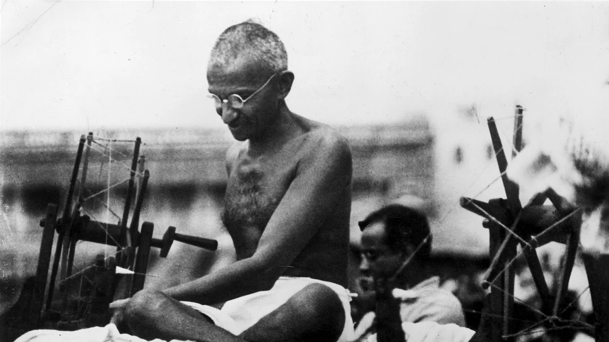 Indian Nationalist leader Mahatma Gandhi (Mohandas Karamchand Gandhi, 1869 - 1948) at a spinning wheel during a 'Charlea' demonstration in Mirzapur, Uttar Pradesh.  (Photo: Getty Images)