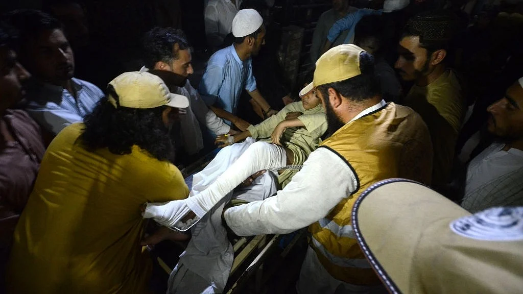 An injured person is shifted to a hospital following a blast targeting a gathering of the Islamic political party JUI-F, in Khyber Pakhtunkhwa on Sunday, July 30. (photo: Getty Images)