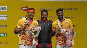 Satwiksairaj Rankireddy and Chirag Shetty with their coach Gopichand after winning the Korea Open title in Yeosu on Sunday, July 23.