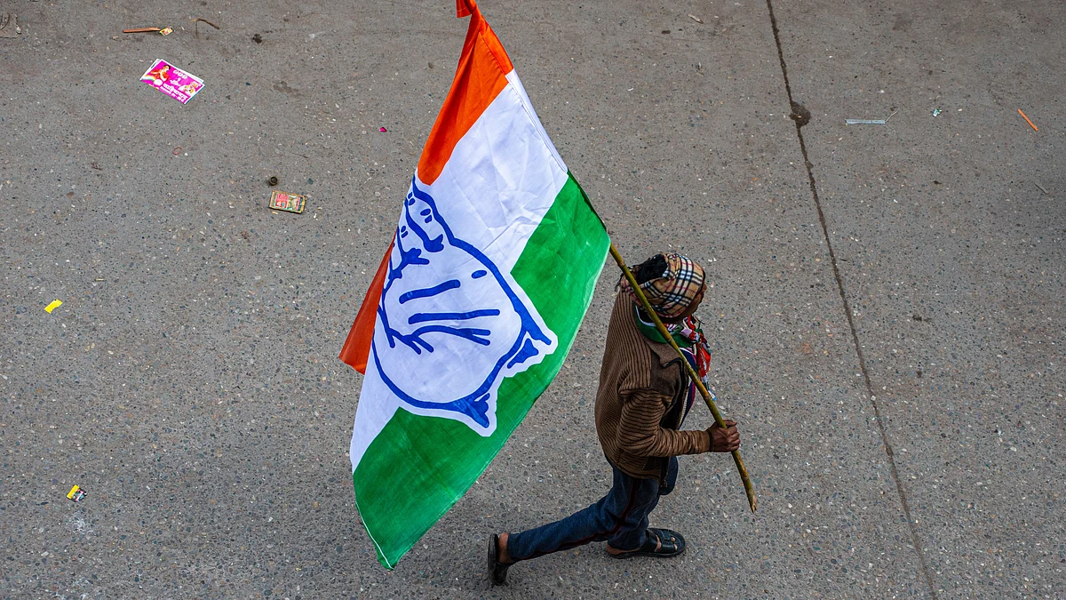 Congress party supporter holds a party flag (Photo: Getty Images