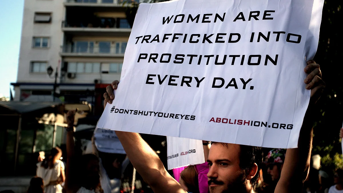 Placard reading 'Women are trafficked into prostitution every day', as part of a street performance by EU non-profit Abolishion to raise awareness of human trafficking and sexual slavery (photo: Giorgos Georgiou/NurPhoto via Getty Images)