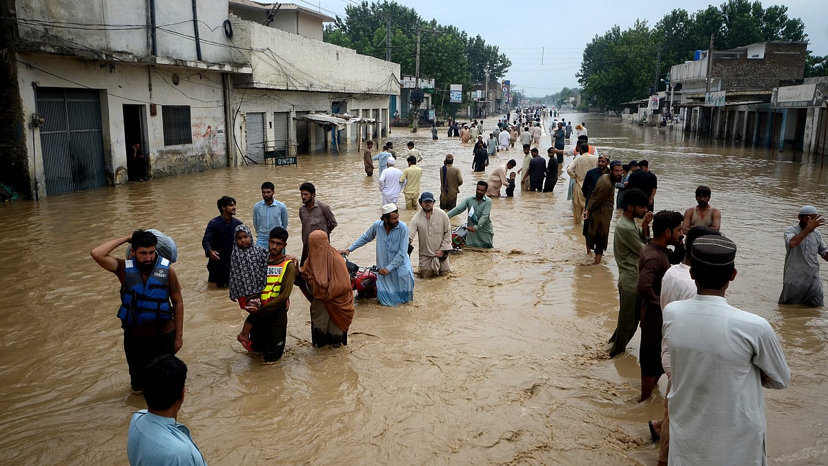 Representative image; displaced people wade through a flooded area. (photo: Getty Images)