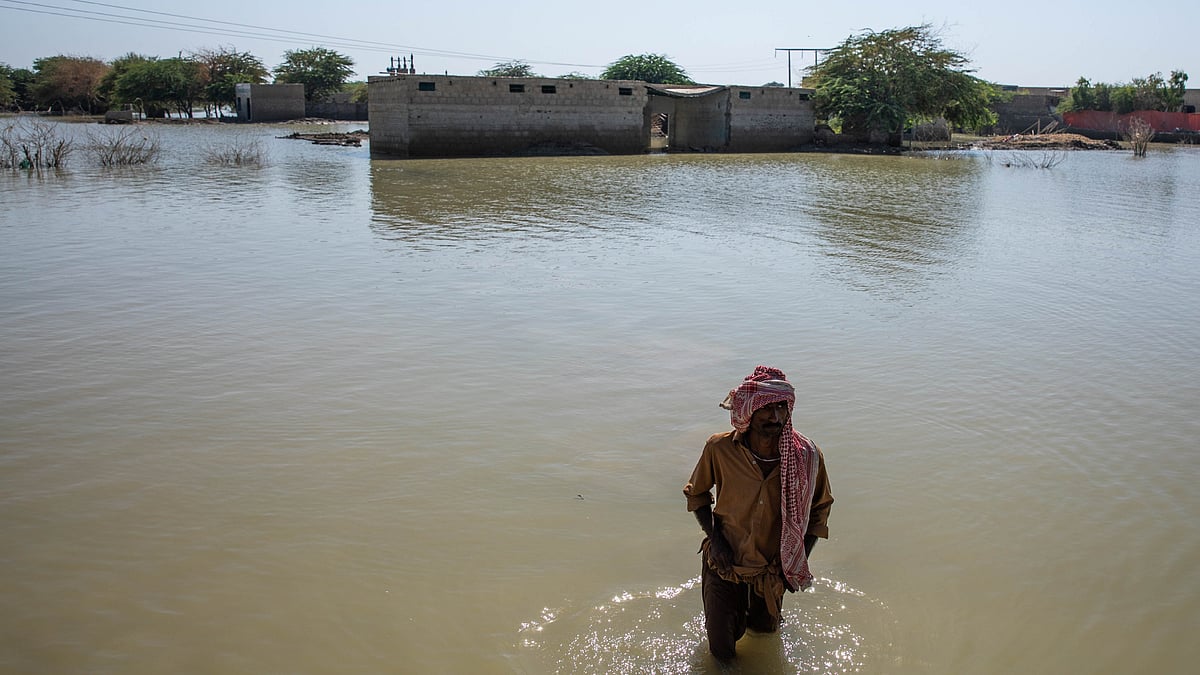 Representative image of a man wading through flooded land (photo: Getty Images)