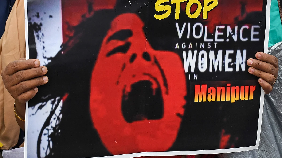 A protester holds a placard during a demonstration against the Manipur violence in Mumbai. It reads 'Stop Violence against Women in Manipur' (photo: Getty Images)