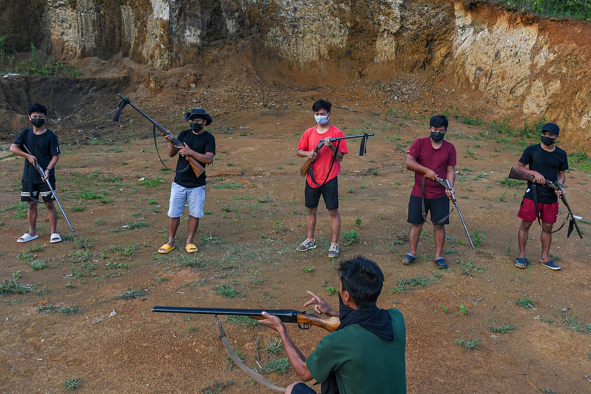 A squad leader trains Kuki youth in loading a cartridge into a single-barrelled rifle during a training session in a village in Churachandpur, Manipur (photo by Biplov Bhuyan/SOPA Images/LightRocket via Getty Images)