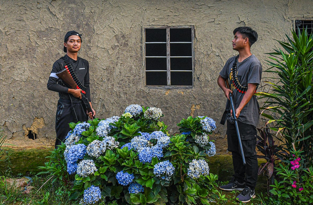 Armed Kuki youths pose for a photo during their frontline operation in Churachandpur district  of Manipur (photo by Biplov Bhuyan/SOPA Images/LightRocket via Getty Images)