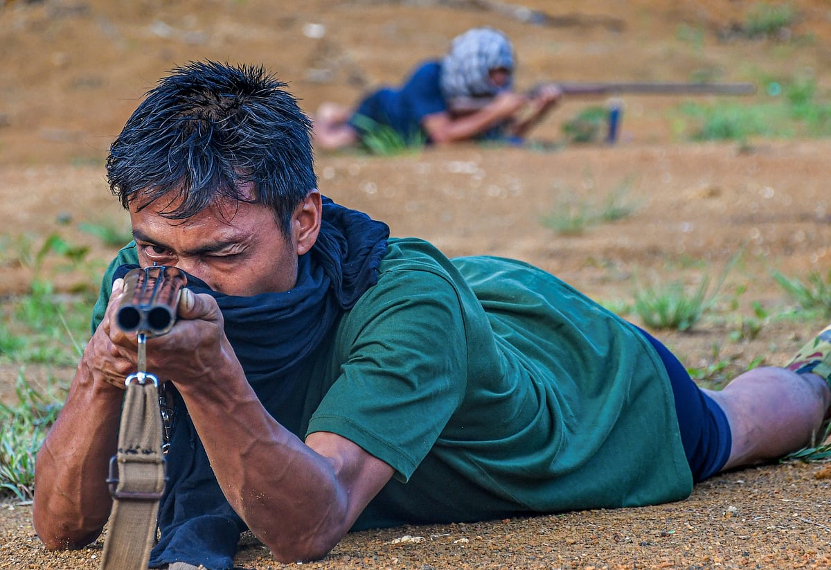 A young volunteer takes aim during a weapons handling training programme near a base camp in Churachandpur. To effectively perform their self-defence duties, Kuki "village volunteers" must undergo rigorous training in handling firearms—how to use a rifle, how to reload— and how to hide from the enemy, how to use a knife in close combat as a last resort, etc (photo by Biplov Bhuyan/SOPA Images/LightRocket via Getty Images)