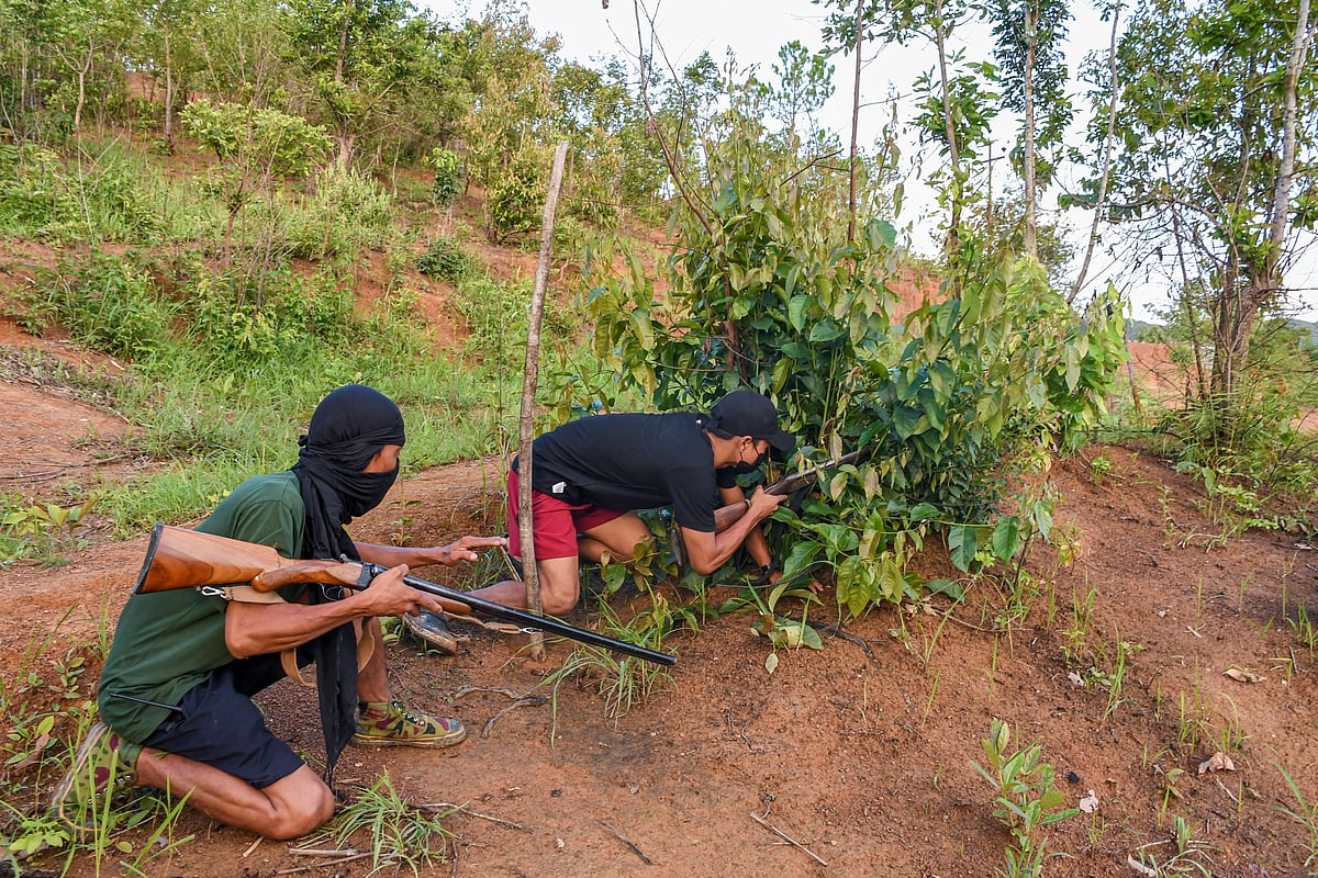 The youthful "village volunteers" learn to hide in the jungle as they shoot to defend their village during enemy attacks (photo by Biplov Bhuyan/SOPA Images/LightRocket via Getty Images)
