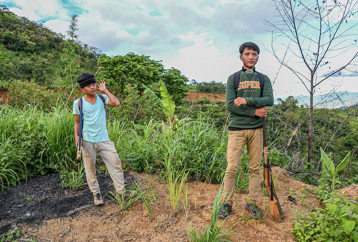 These armed Kuki boys take pride in their role as defenders of their homes and families and land. These two are waiting near a checkpoint in Churachandpur with their rifles, as you do, for their friends (photo by Biplov Bhuyan/SOPA Images/LightRocket via Getty Images)