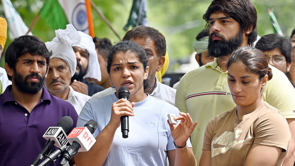 Wrestlers Vinesh Phogat, Sakshi Malik and Bajrang Punia speak with the media during their protest against Wrestling Federation of India (WFI) chief Brij Bhushan Sharan Singh at Jantar Mantar. (photo: getty images)