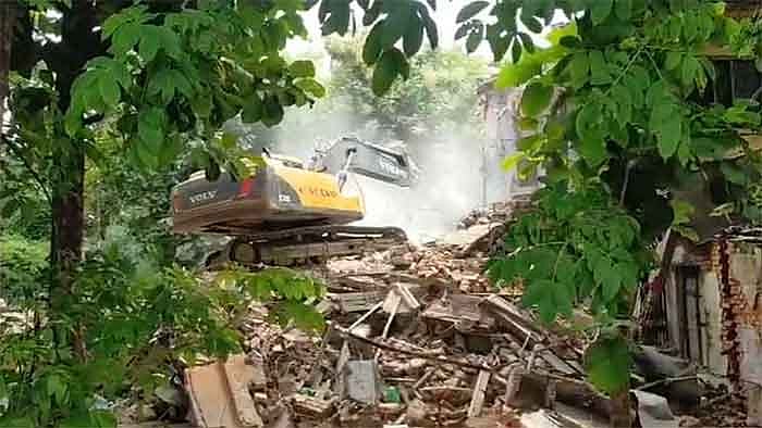 A bulldozer pulls down structures at Sarva Seva Sangh campus in Varanasi (Photo courtesy: social media/ X)