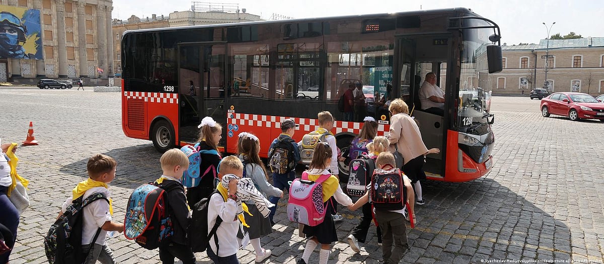 Shuttle home: Once the school day has ended, the safest way available to ferry the children home is by bus—like this one waiting in the main square to take them from the metro station housing their school to their homes