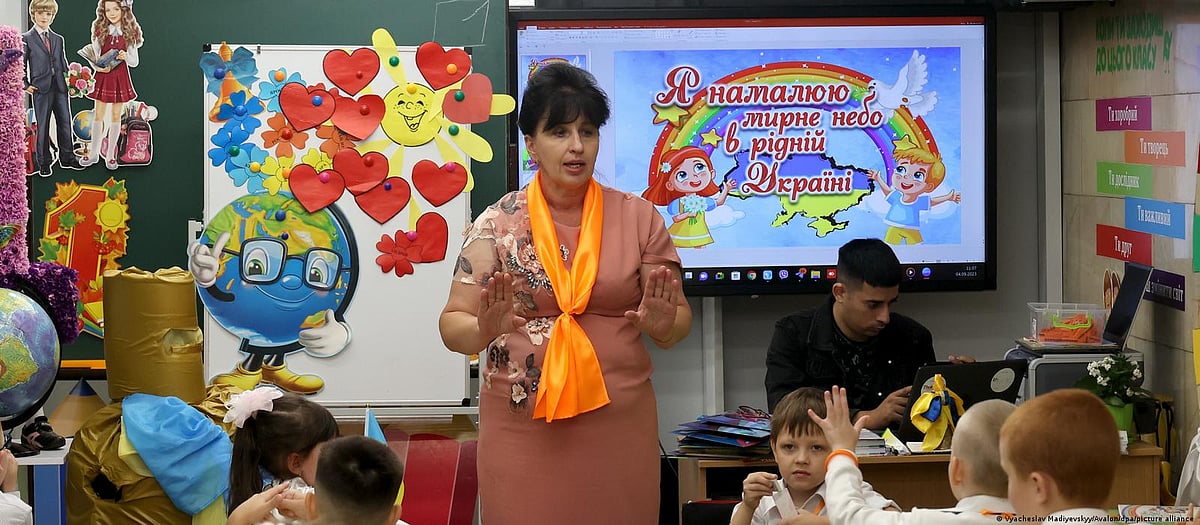 Colourful classrooms: A teacher welcomes her flock back to school. Teachers are working hard to offer their class a bright and cheerful space, despite the gloomy circumstances, so the children can have as peaceful and sheltered a learning environment as possible.
