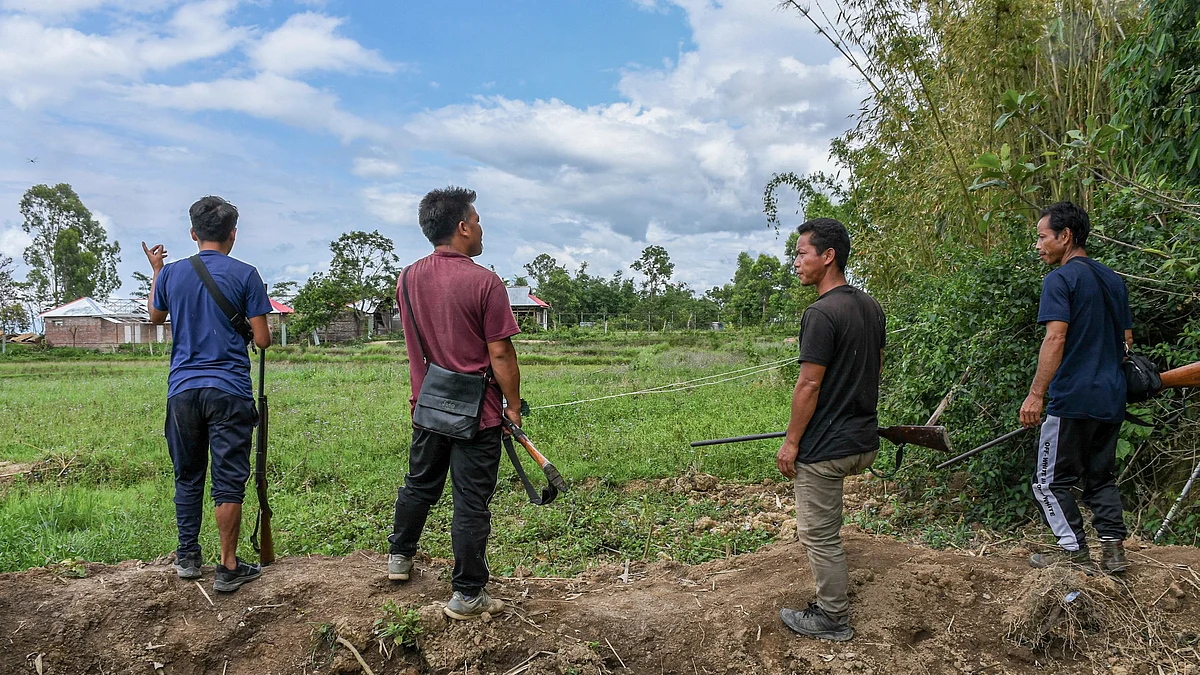 Armed Kuki men guard a village in Manipur as part of a village defence force with single-barrel rifles (photo: Getty Images)