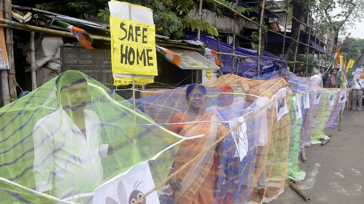 Congress activists in Kolkata stand inside mosquito nets during a protest against rising dengue cases in West Bengal (photo: Getty Images)