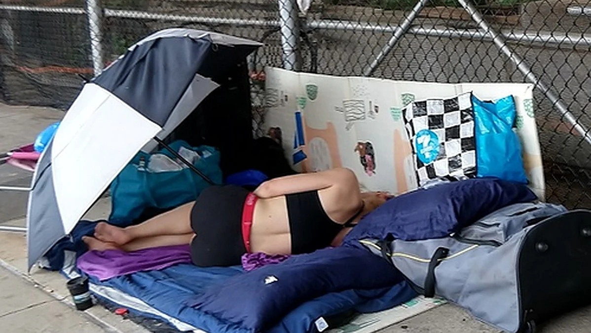 A homeless person sleeps under an umbrella (Photo: IANS)