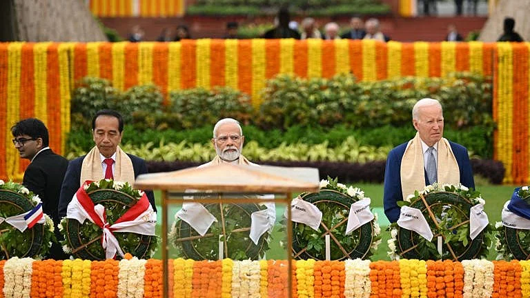 From left: Indonesia's president Joko Widodo, India's PM Narendra Modi and US president Joe Biden at the Mahatma Gandhi memorial in Rajghat (photo: Getty Images)