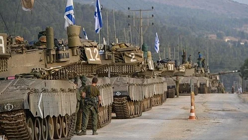 Israeli tanks positioning themselves on the border fence with Gaza (Photo: IANS)