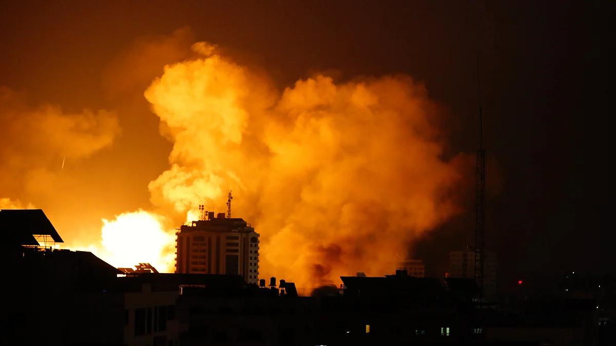 A plume of smoke rises in the sky over Gaza City during an Israeli airstrike (photo: Getty Images)