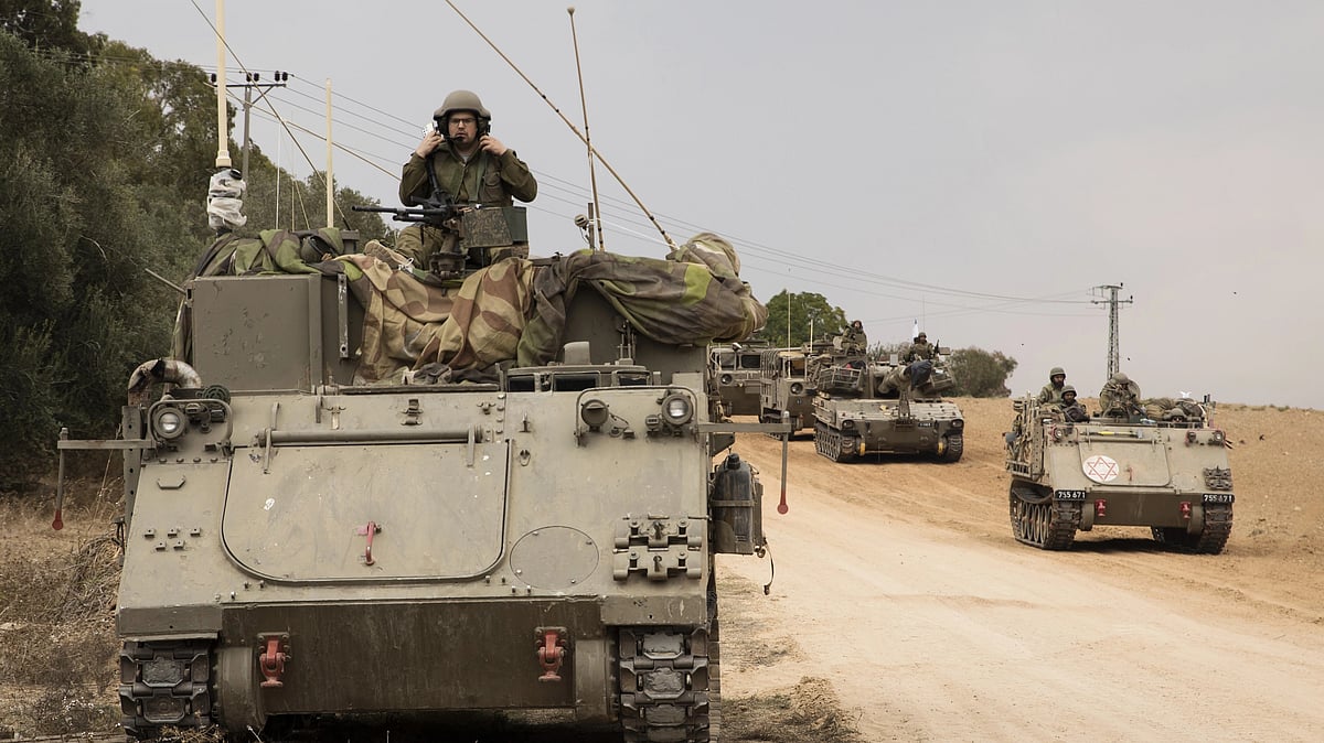 Israeli armored personnel carriers drive toward the Israeli southern border with the Gaza Strip on October 9 (Photo by Amir Levy/Getty Images)