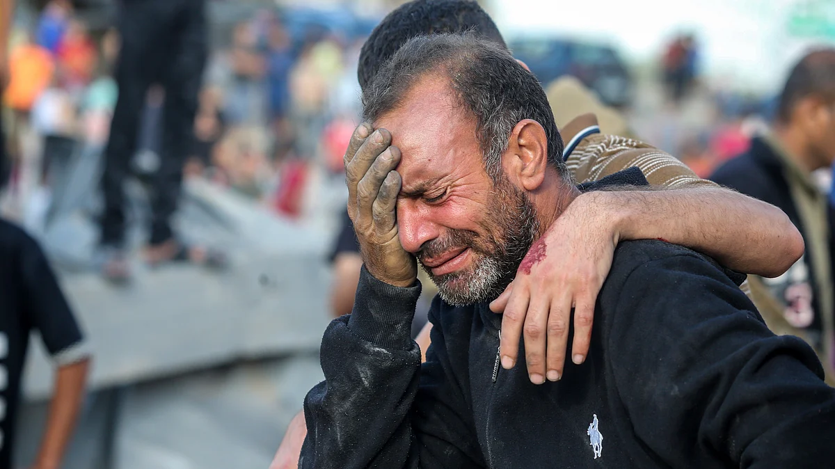 A man cries as his home is bombed during Israeli air raids on Gaza, 16 Oct. (photo: Getty Images)