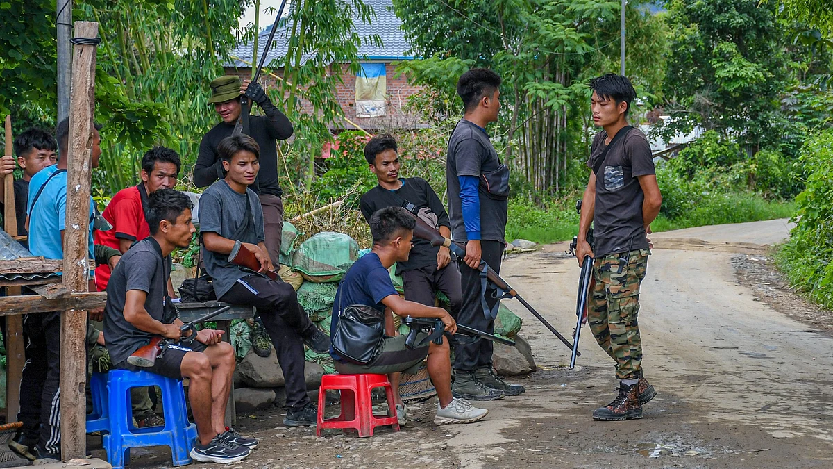 Kuki men guard a checkpoint in Churachandpur district in Manipur, arming themselves with single-barrel rifles approved by the state government (photo: Getty Images)