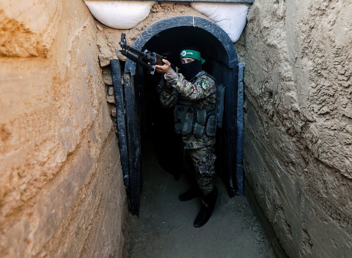 A fighter from Izz al-Din al-Qassam stands guard at an exhibition of weapons, missiles and heavy equipment for the military wing of Hamas in central Gaza Strip in July (photo: Getty Images)