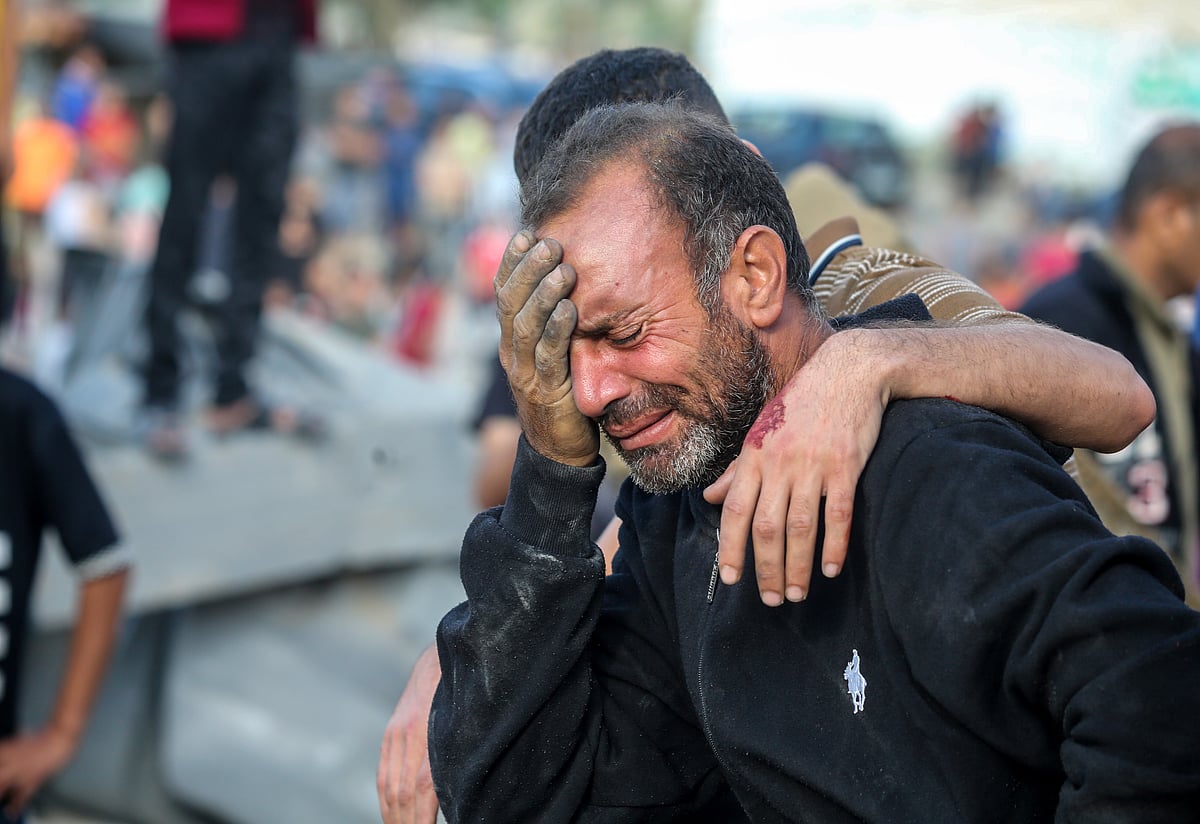 A man cries as his home is bombed during Israeli air raids on 16 October in Khan Yunis, Gaza (photo: Getty Images)