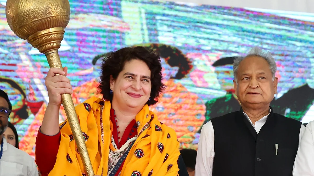 Congress leader Priyanka Gandhi (left) wields a golden mace smilingly, next to incumbent chief minister Ashok Gehlot (Photo: @priyankagandhi/X)