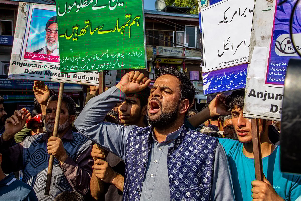 "We stand with the oppressed people of Palestine," reads a placard held by a Kashmri protestor, on 13 October in Budgam, Kashmir (photo: Getty Images)