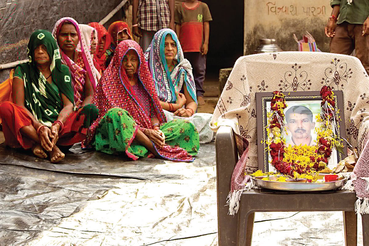 Vajesinh’s relatives mourn his death.