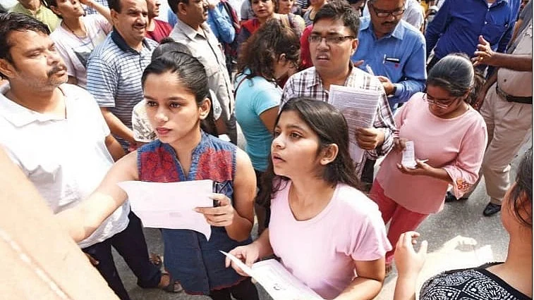 Students check the list before the NEET medical entrance exam at a private school in Delhi (photo: Getty Images)
