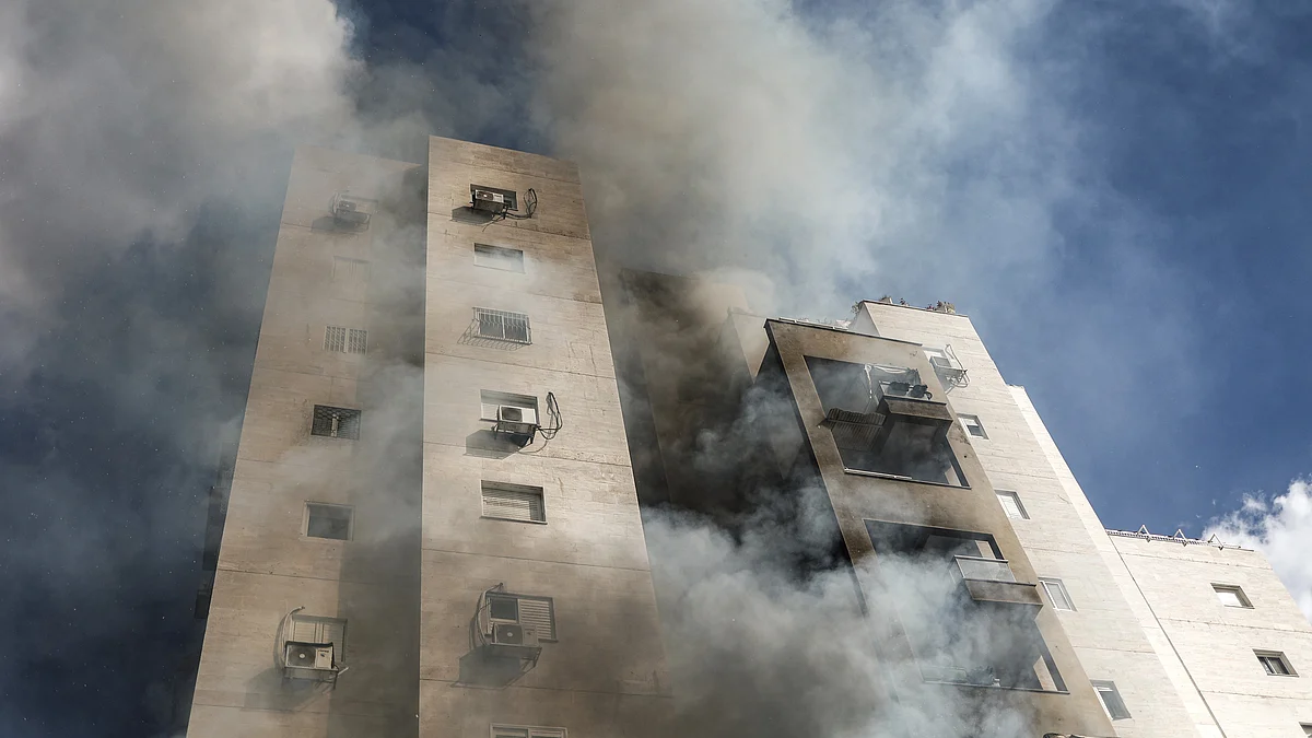 Smoke billows from a residential building following a rocket attack from Gaza (photo: Getty Images)