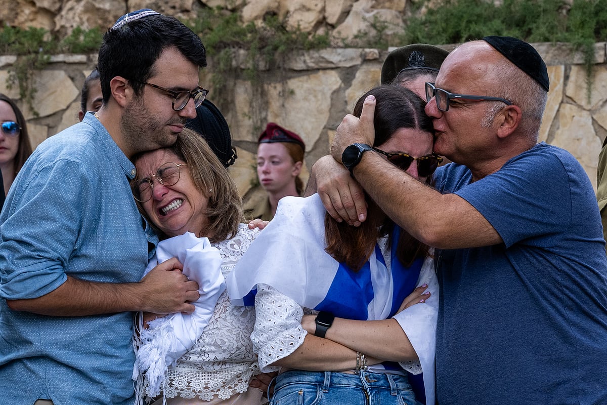 The family of Valentin Ghnassia, 23, who was killed in a battle with Hamas militants at Kibbutz Be’eeri near the Israel-Gaza border (photo: Getty Images)