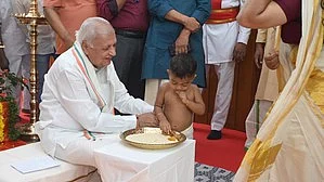 Governor Arif Mohammed Khan joined the tradition this year by assisting 61 children in writing their first letters. (Photo: IANS)