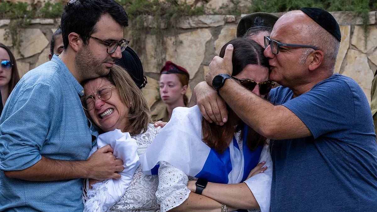 The mother (L), sister (R) and immediate family of Valentin (Eli) Ghnassia, 23, who was killed in a battle with Hamas militants react during his funeral ceremony (Photo by Alexi J. Rosenfeld/Getty Images)