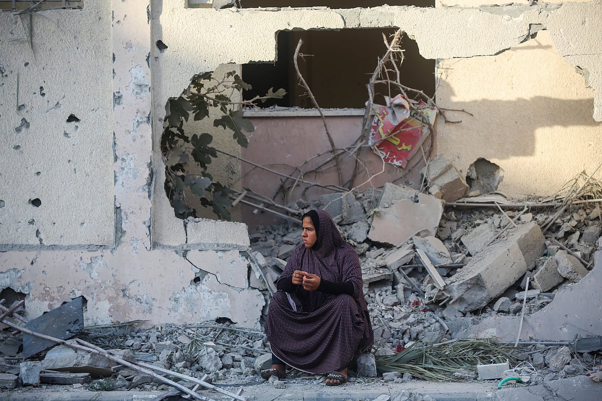 KHAN YOUNIS, GAZA - OCTOBER 17: Palestinian citizen inspects their home destroyed during Israeli air raids in the southern Gaza Strip on October 17, 2023 in Khan Yunis, Gaza. Gazans are evacuating to the south as advised by the Israeli government, ahead of an expected Israeli ground offensive. Israel has sealed off Gaza, leaving the entire population without fuel, water or aid, and launched sustained retaliatory air strikes, which have killed more than 2,000 people and some 400,000 displaced, after a large-scale attack by Hamas. On October 7, the Palestinian militant group Hamas launched a surprise attack on Israel from Gaza by land, sea, and air, killing over 1,300 people and wounding around 2,800. Israeli soldiers and civilians have also been taken hostage by Hamas and moved into Gaza. The attack prompted a declaration of war by Israeli Prime Minister Benjamin Netanyahu and the announcement of an emergency wartime government. (Photo by Ahmad Hasaballah/Getty Images)