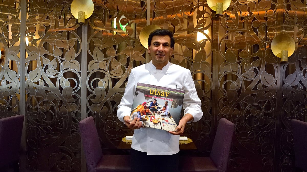 New York-based Indian Michelin-starred chef, Vikas Khanna with his book, Utsav - A culinary epic of Indian festivals - that he photographed across India for 12 years (Photo: Rubina A. Khan/Getty Images)