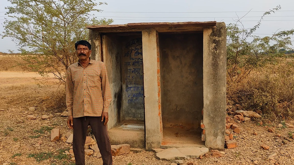 Mangi Lal, a Dalit resident of Mandsaur's Panch Khaira village, standing outside a toilet constructed 5-6 years back. The toilet has no septic tank. (photo: Kashif Kakvi) 