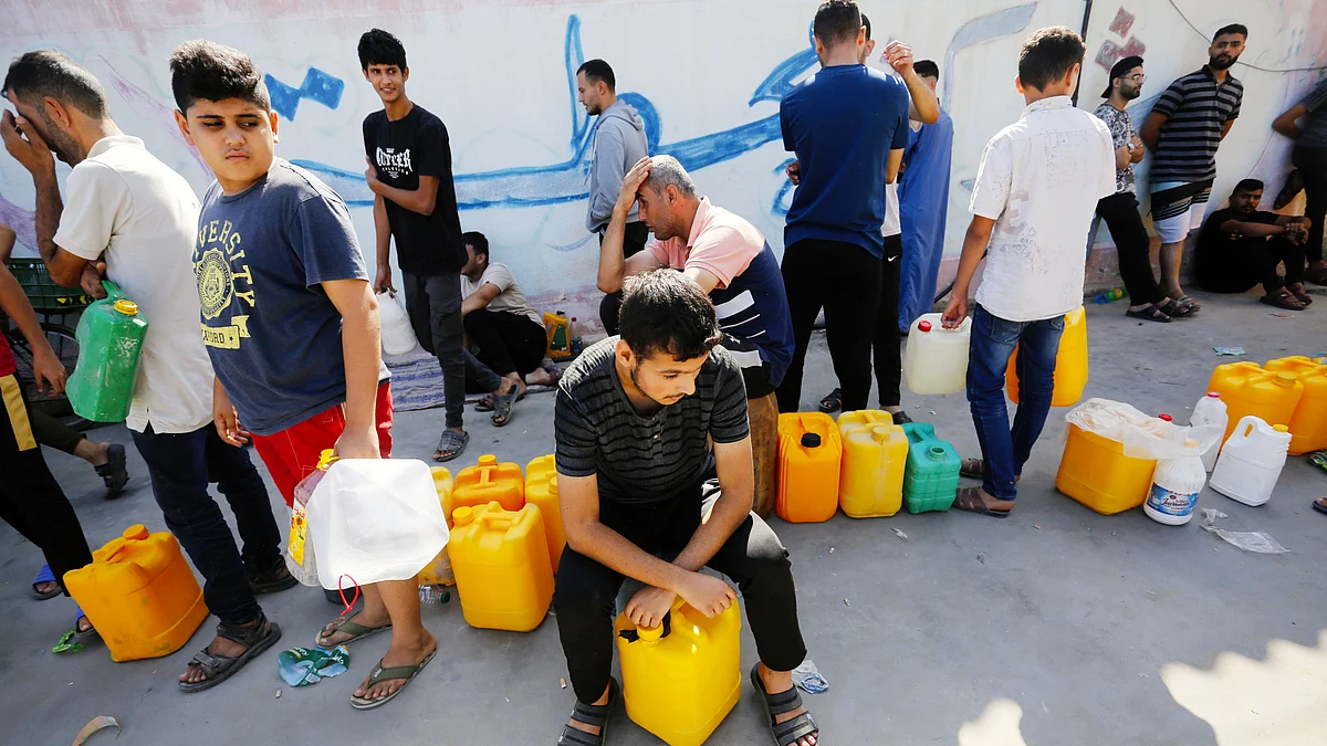 File photo of Gaza residents in front of a gas station in search of fuel on 19 October (photo: Getty Images)
